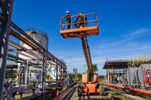 two construction men on a boom lift for a job
